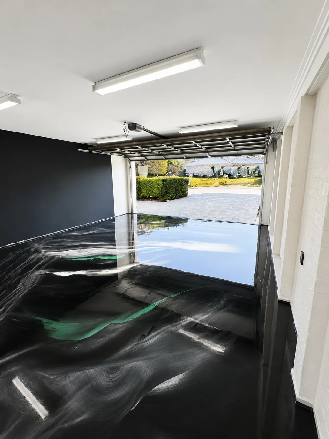 Black and emerald metallic epoxy garage floor